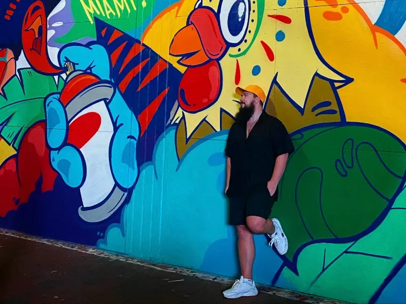 Guide Mikhail at a rooster mural in Little Havana, Miami