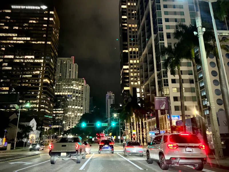 Evening traffic on Brickell Avenue between office and condo towers, Miami