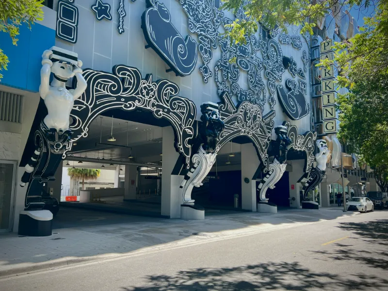 Sculpted figures at the arched entrances of a parking garage in the Miami Design District