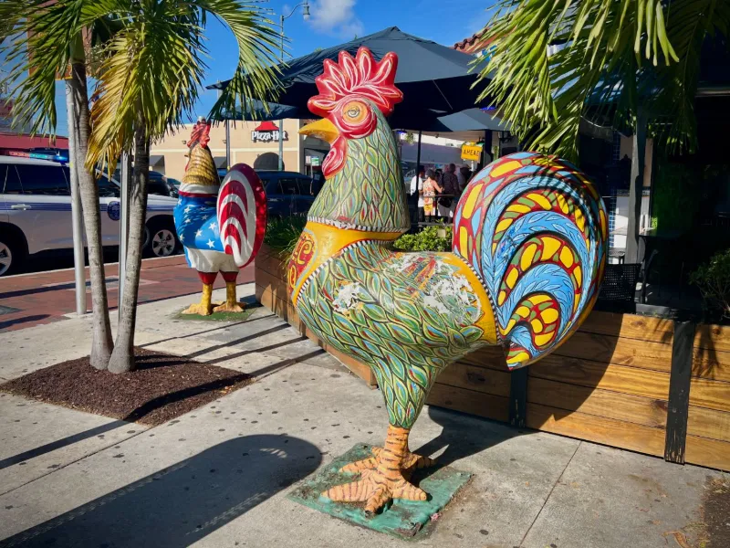 Painted rooster statues on a Calle Ocho sidewalk, Little Havana, Miami