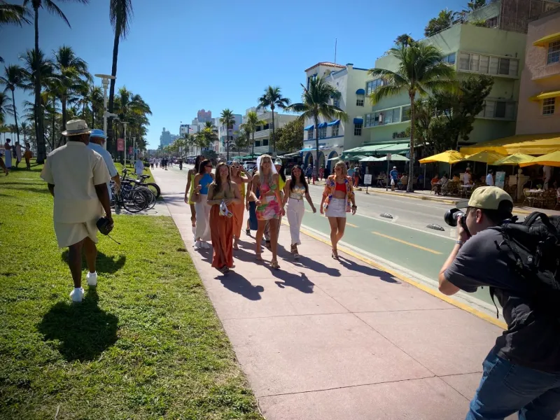 People walking the Ocean Drive promenade by Lummus Park, South Beach, Miami Beach